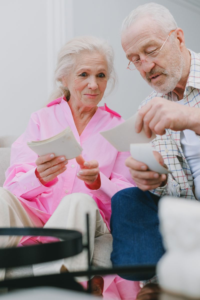 Elderly couple looking at photographs - Senior Whole Life